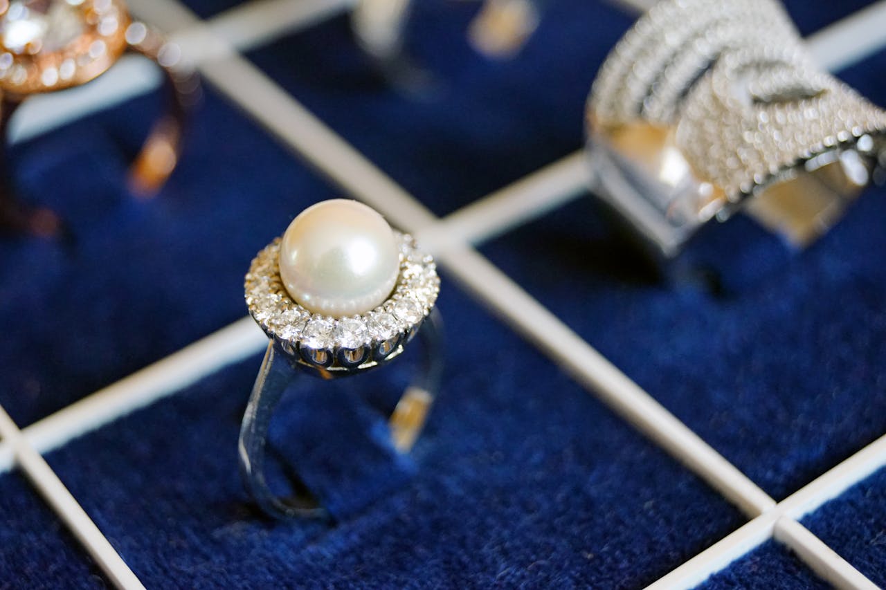 Crafting Captivating Headlines: Your awesome post title goes here Close-up of a pearl ring with diamonds on a luxurious display.