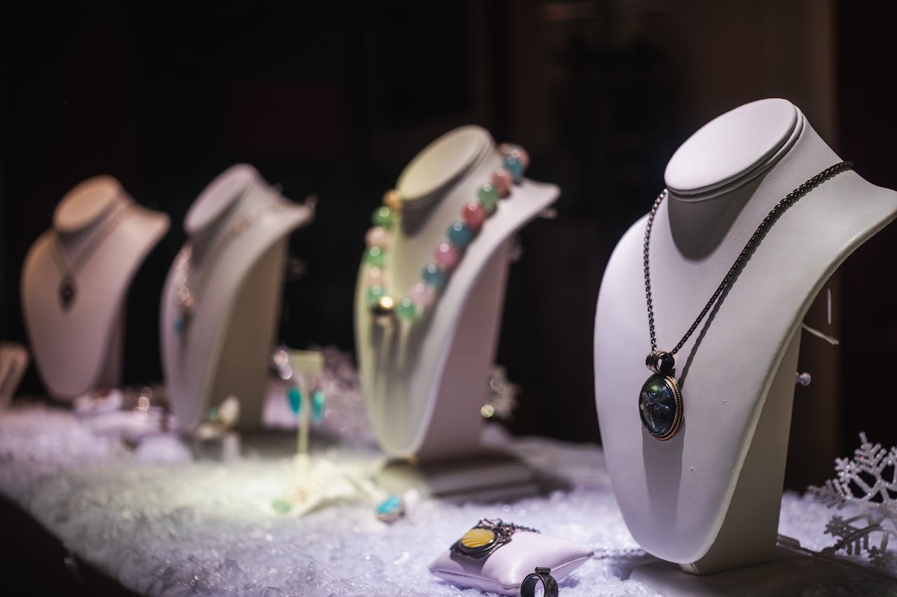 A refined display of luxurious necklaces on mannequins in a jewelry store.