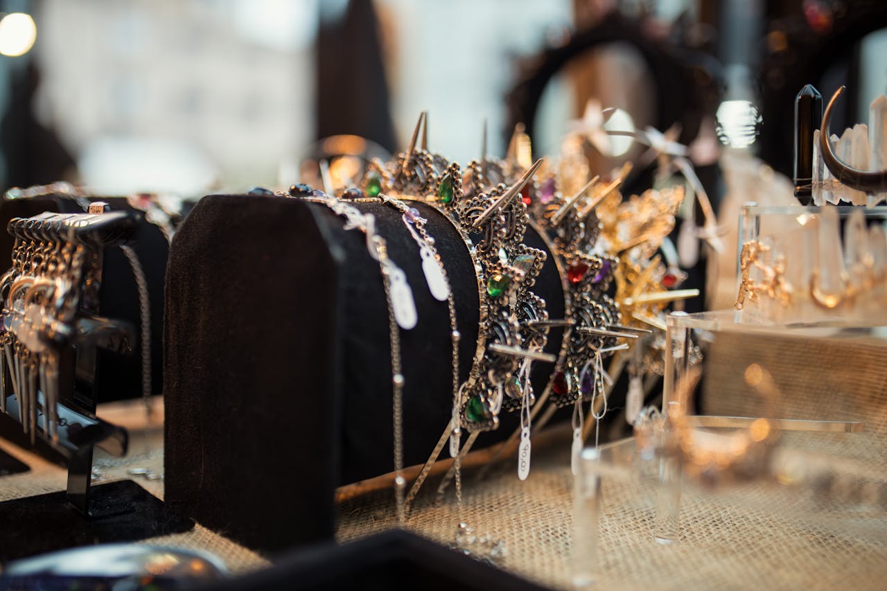 The Art of Drawing Readers In: Your attractive post title goes here Crown and jewelry display showcasing elegant gemstones and intricate designs on a velvet stand.